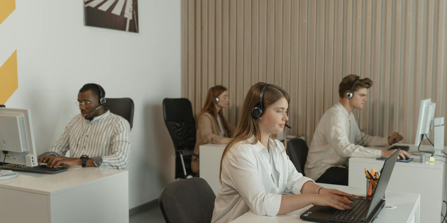 four people working in call center office